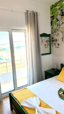 a bedroom with a bed and a large window at D&R Sunshine Apartment in Agia Marina Nea Kydonias