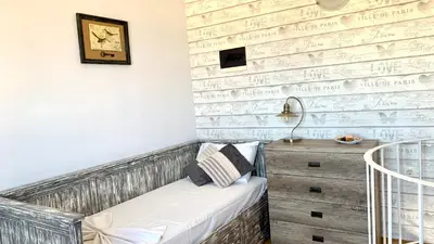 a room with a bench and a brick wall at D&R Sunshine Apartment in Agia Marina Nea Kydonias