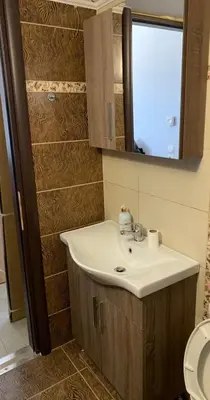 a bathroom with a sink and a mirror at D&R Sunshine Apartment in Agia Marina Nea Kydonias