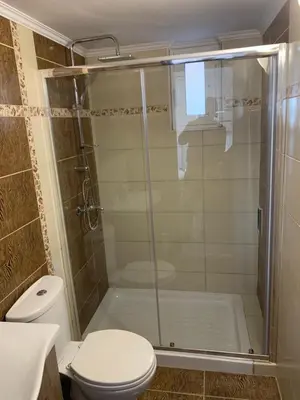 a bathroom with a shower and a toilet at D&R Sunshine Apartment in Agia Marina Nea Kydonias