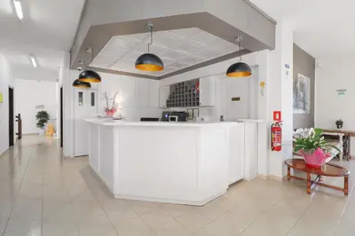 a kitchen with a white island in a room at Alexis Hotel in Chania Town