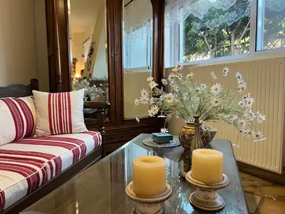 a living room with a couch and a table with candles at Ammos Beachfront House by 8essentially in Kato Daratso