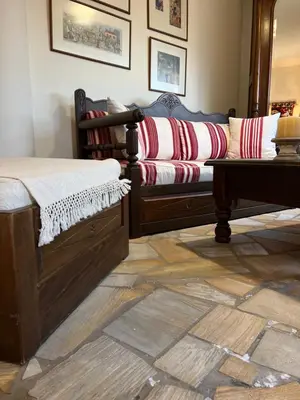 a room with a bed and a couch and a table at Ammos Beachfront House by 8essentially in Kato Daratso