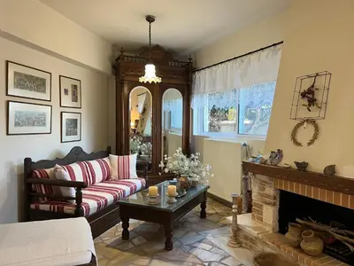 a living room with a couch and a fireplace at Ammos Beachfront House by 8essentially in Kato Daratso