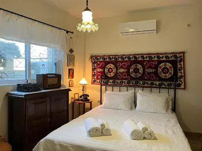 a bedroom with a bed with towels on it at Ammos Beachfront House by 8essentially in Kato Daratso