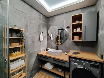 a bathroom with a washing machine and a mirror at Thelma and Louise house in Mourniaí