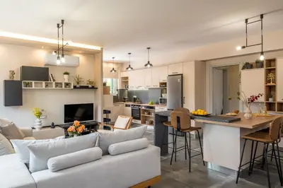 a living room and kitchen with a couch and a table at Thelma and Louise house in Mourniaí