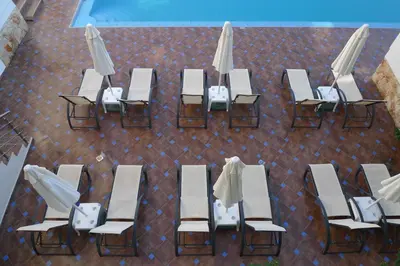 an overhead view of tables and chairs and umbrellas at Theros Hotel in Tavronitis