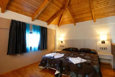 a bedroom with a large bed and a window at Theros Hotel in Tavronitis