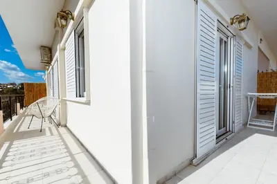a balcony with a chair and windows on a building at Porfyra Suite 2 in Chania Town
