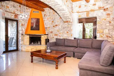 a living room with a couch and a fireplace at Villa Vicina - In Platanias and 4min by the beach in Chania Town