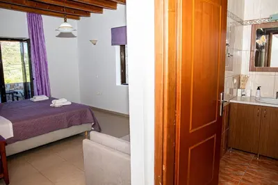 a bedroom with a bed and a bathroom with a sink at Villa Vicina - In Platanias and 4min by the beach in Chania Town