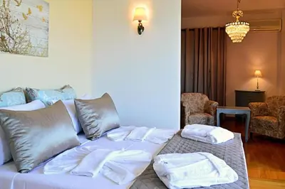 a white bed with towels on it in a room at Villa Sobre - Spacious and Comfortable. in Kounoupidhianá