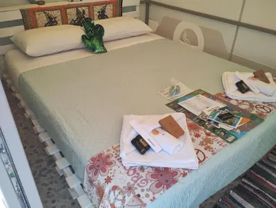 a bed with two towels and a toy on it at Cornelia Hippie Magic Bus in Kissamos