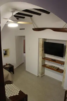 a living room with a flat screen tv on a wall at Evanthea Residence in Kounoupidhianá