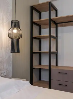 a bedroom with a book shelf and a bed at Orama Luxury Apartments in Agia Marina Nea Kydonias