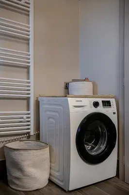a washing machine in a closet with a basket at Emmanuel's Sea View Luxury Apartment in Kissamos