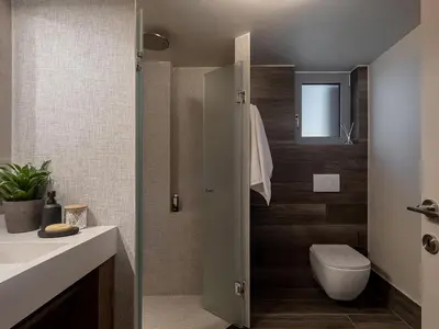 a bathroom with a toilet and a sink at Emmanuel's Sea View Luxury Apartment in Kissamos