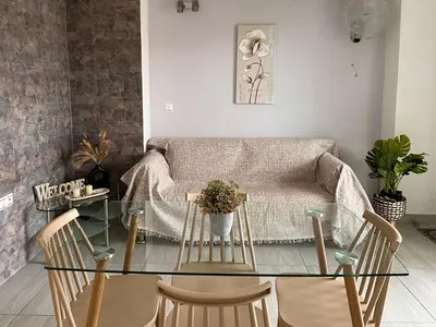 a living room with a glass table and a couch at Beachfront villa Agia Marina in Stalos