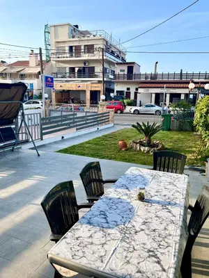 a table and chairs sitting on a patio at Beachfront villa Agia Marina in Stalos