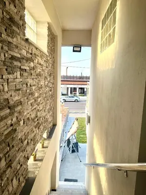 a hallway of a house with a stone wall at Beachfront villa Agia Marina in Stalos