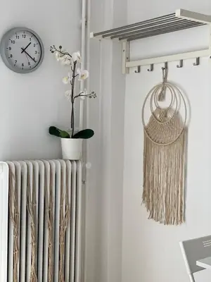 a radiator and a clock on a wall with a plant at maren apartment in Chania Town
