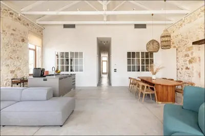 a kitchen and living room with a table and chairs at PETRA - casa casa group in Chania Town