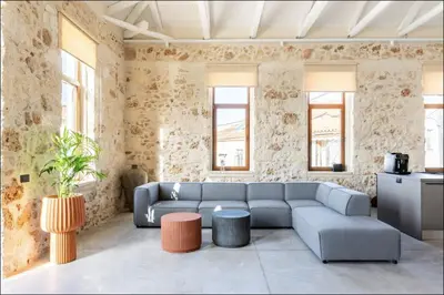 a living room with a couch and a table at PETRA - casa casa group in Chania Town