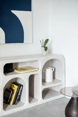 a white book shelf with books and a table at ALS - casa casa group in Chania Town