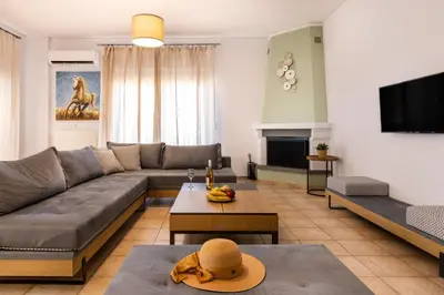 a living room with a couch and a table at Blue Port in Chania in Souda