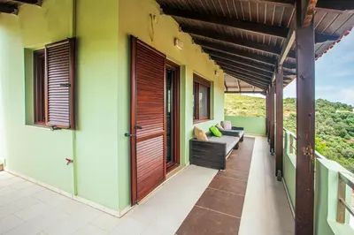 a balcony of a house with a couch at Villa Chloe - Amazing view Villa with swimming pool in Chania Town