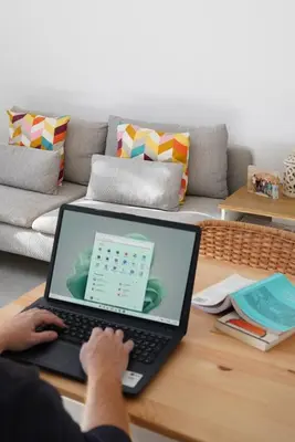 a person is typing on a laptop on a coffee table at Lindas Convent Garden Home 1 in Chania Town