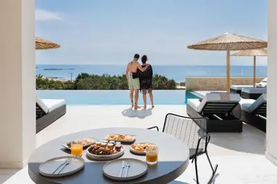 two people standing on a patio with a table with food at Actea Seaview Villas I 