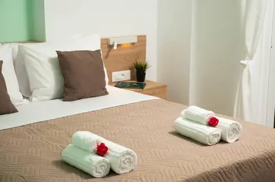 a bedroom with a bed with four towels on it at New cozy apartment near the center of Chania in Chania Town
