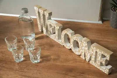 a table with glasses and a bottle on a table at New cozy apartment near the center of Chania in Chania Town