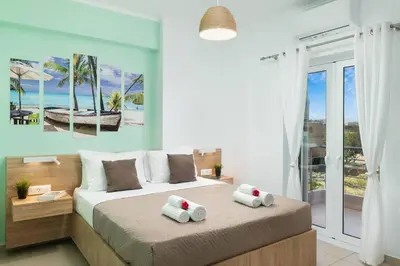 a bedroom with a bed with two towels on it at New cozy apartment near the center of Chania in Chania Town