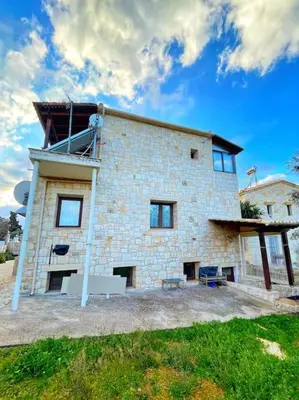a large brick building with a sky background at Kathiana cozy apartment in Kathiana