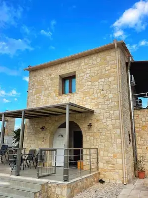 a brick building with a balcony and a patio at Kathiana cozy apartment in Kathiana