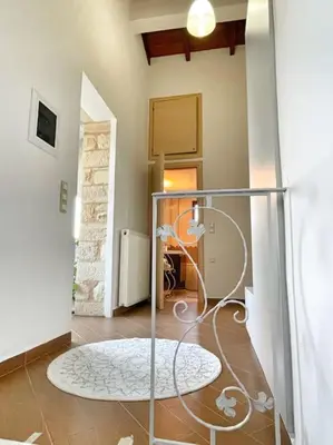a room with a hallway with a circular rug on the floor at Kathiana cozy apartment in Kathiana