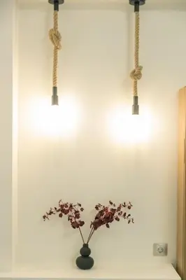 a plant in a vase on a shelf with lights at The Alcove Studio Chania in Chania Town