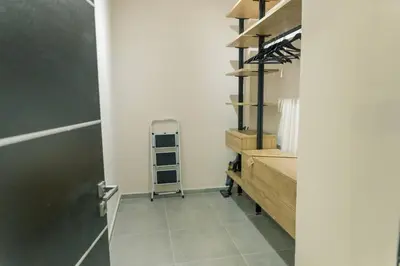 a hallway with a walk in closet with a metal ladder at The Alcove Studio Chania in Chania Town