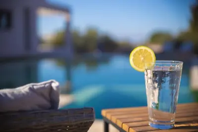 a glass of water with a lemon slice on a table at The Alcove Studio Chania in Chania Town