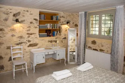 a bedroom with a desk and a table and a mirror at DOLONAS Cosy House in Aliyoí