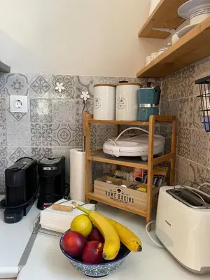 a kitchen counter with a bowl of fruit and a toaster at DOLONAS Cosy House in Aliyoí