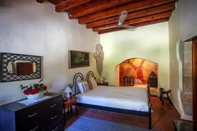a bedroom with a bed and a dresser in a room at Villa Polirinia in Kissamos