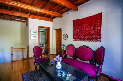 a living room with purple chairs and a table at Villa Polirinia in Kissamos