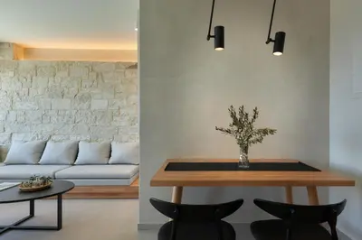 a living room with a table and a couch at Pachnes Luxury Apartments - Heated Pool, Sea View in Kounoupidhianá