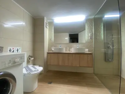 a bathroom with two sinks and a shower at Be Crete - vista Lazareta in Chania Town