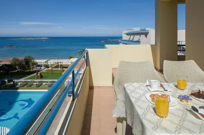 a balcony with a table and a view of the ocean at Be Crete - vista Lazareta in Chania Town