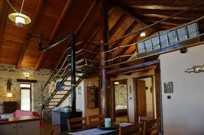 a room with a spiral staircase in a building at Elpida Country House -Paleochora-Anidri in Palaiochóra